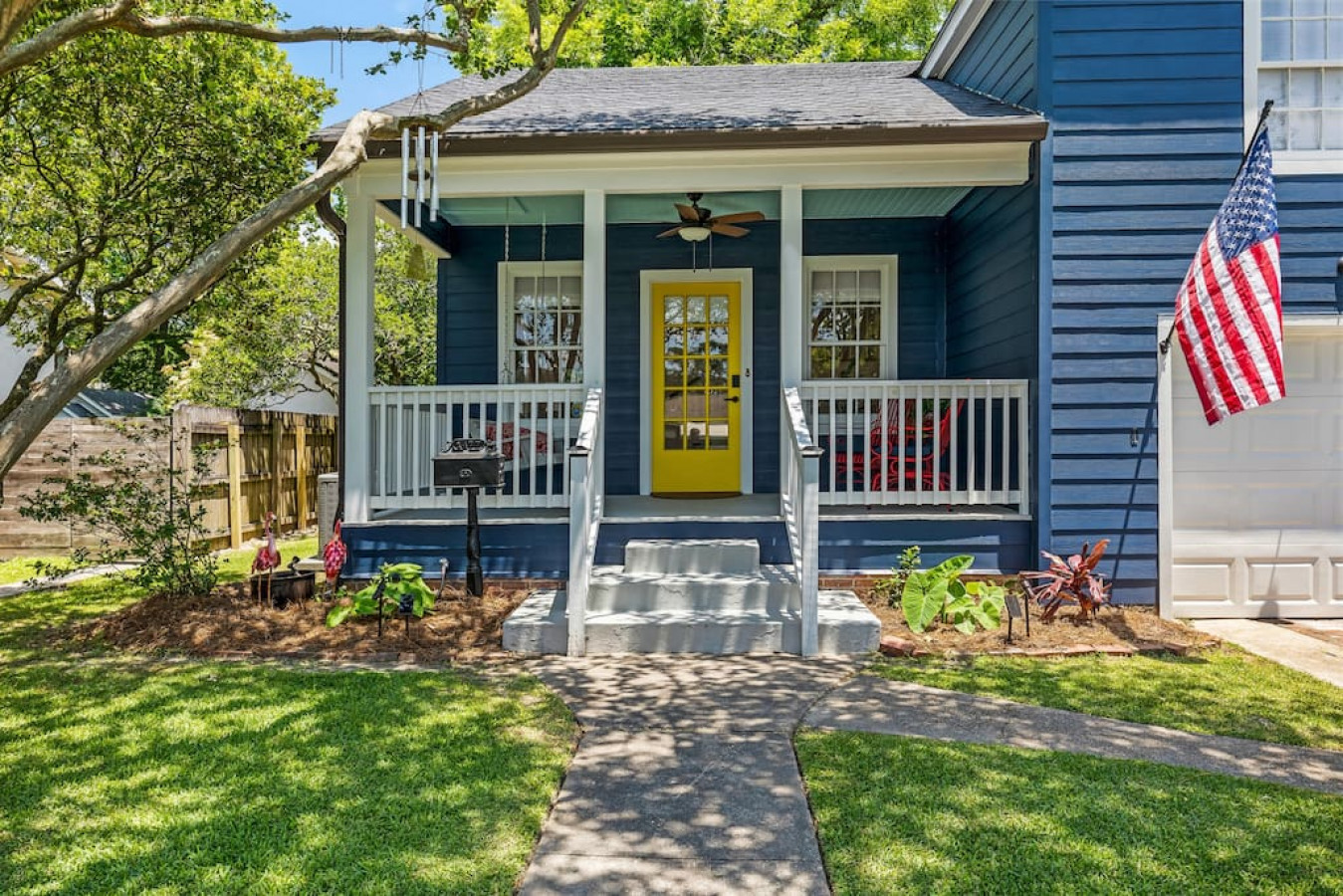 Blue Garden District home with a yellow front door